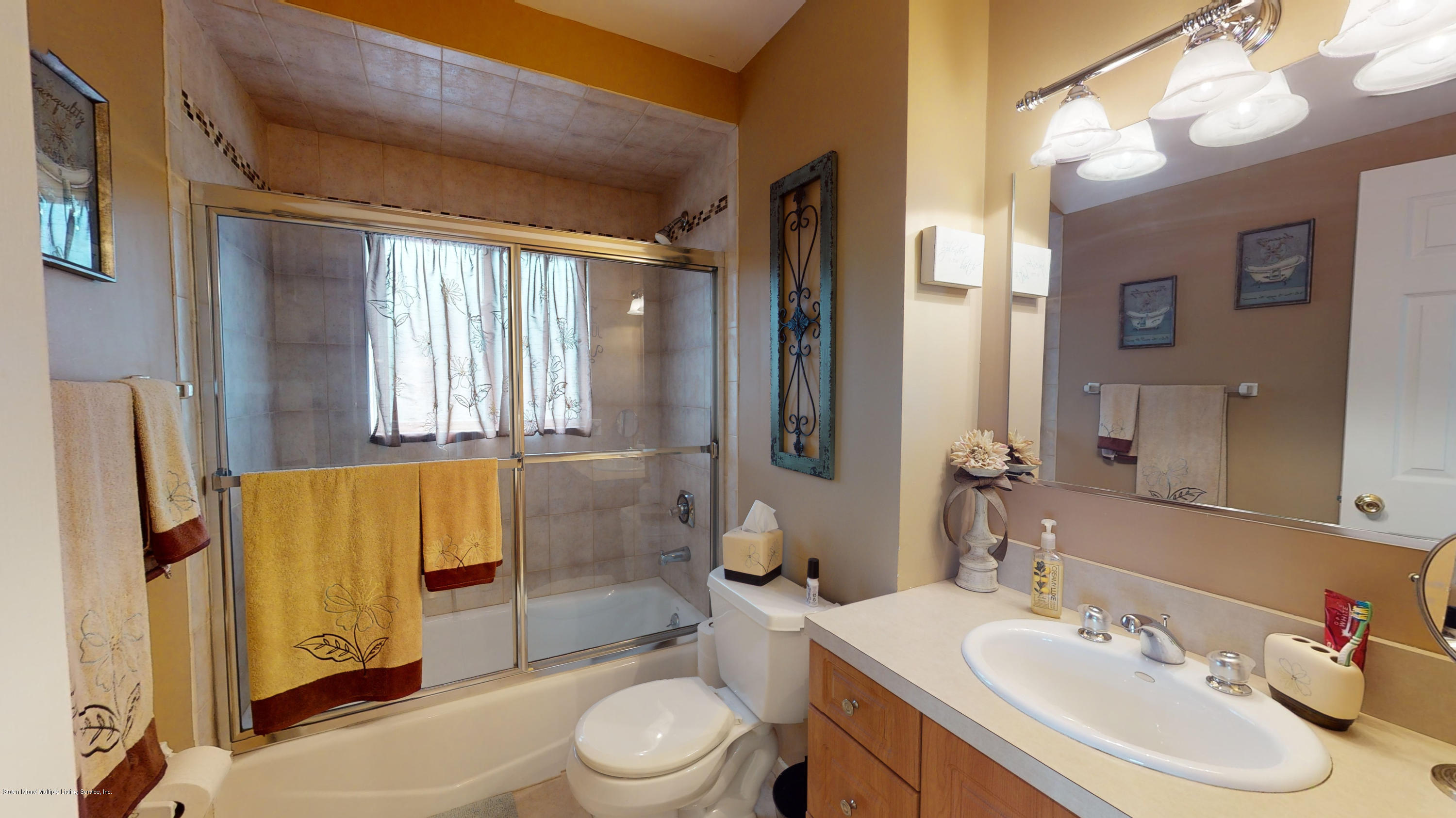 103 Covington Circle Staten Island, NY 10312 - Photo 9 of 21 a bathroom with a sink toilet and shower