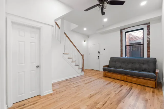 a living room with furniture and a wooden floor