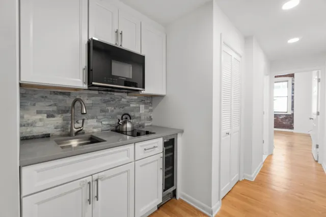a kitchen with sink stainless steel appliances and cabinets