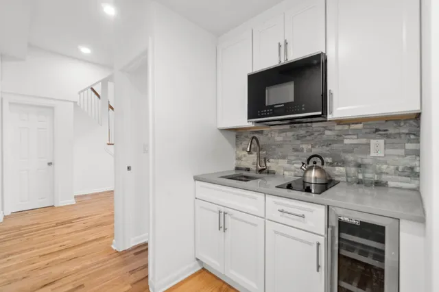 a kitchen with stainless steel appliances a stove microwave and sink