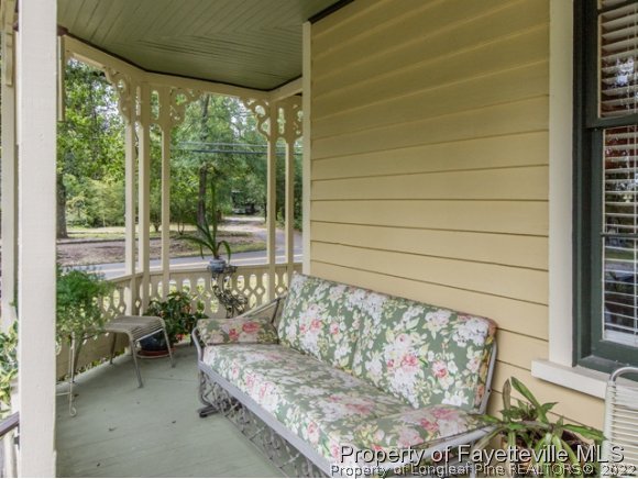 524 Carthage Street Cameron, NC 28326 - Photo 13 of 16 a living room with furniture and a potted plant