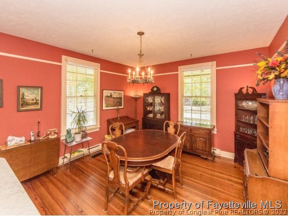 524 Carthage Street Cameron, NC 28326 - Photo 7 of 16 a dining room with furniture a chandelier and wooden floor