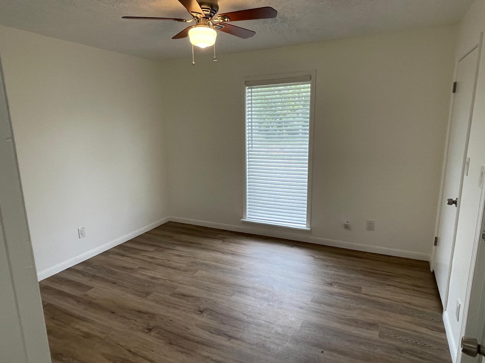 335 Carroll Road Richmond, TX 77469 - Photo 18 of 25 an empty room with wooden floor closet and windows