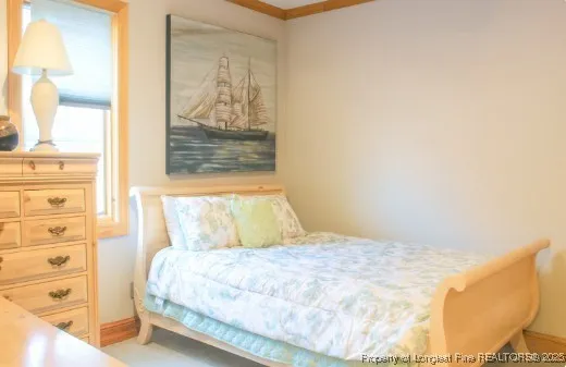 a bedroom with a bed and with view of living room