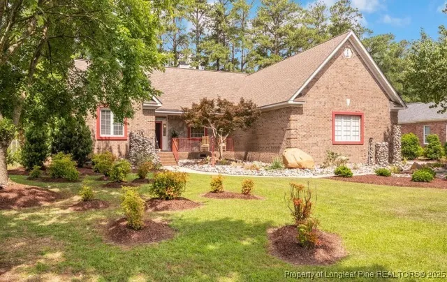 a view of a house with swimming pool and sitting area