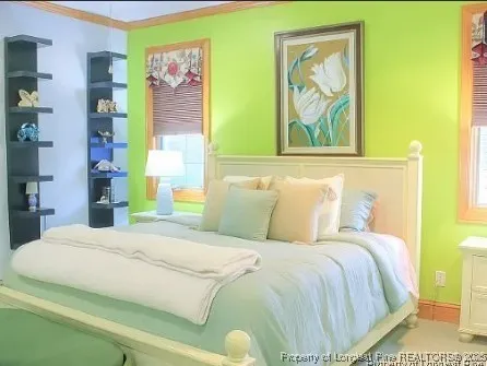 a bedroom with a bed and a painting on the wall