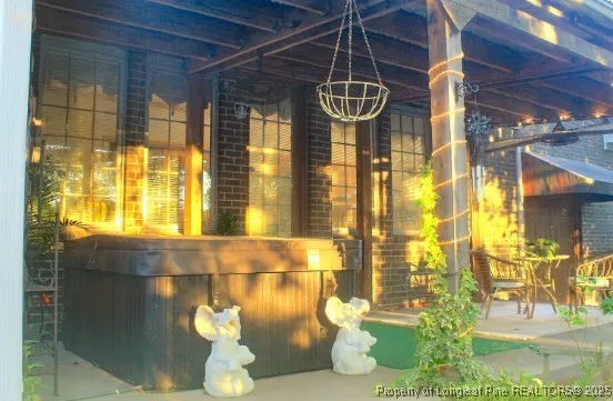 a patio with glass windows and table
