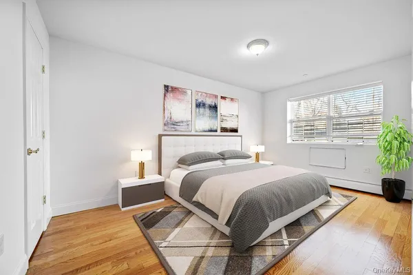 a bedroom with a bed and a large window