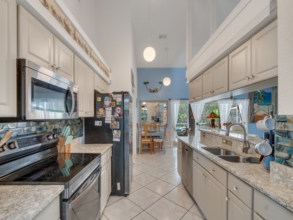 10615 Highway 1 Sebastian, FL 32958 - Photo 11 of 33 a kitchen with stainless steel appliances granite countertop a sink and a stove
