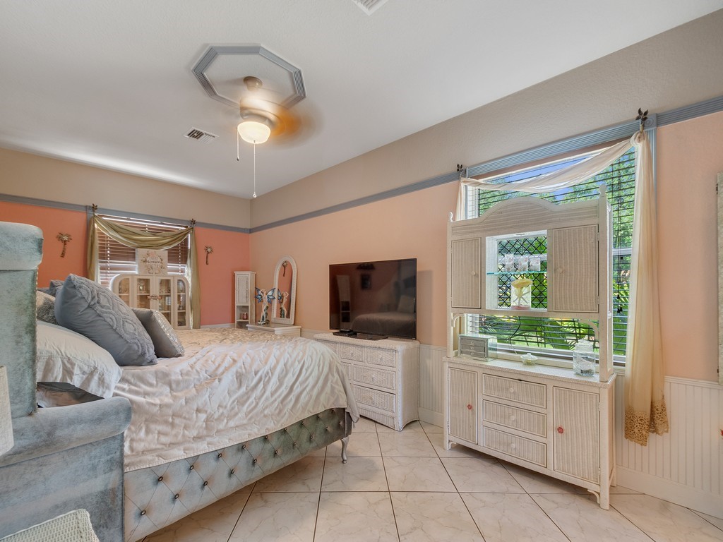 10615 Highway 1 Sebastian, FL 32958 - Photo 15 of 33 a bedroom with a bed and a flat screen tv