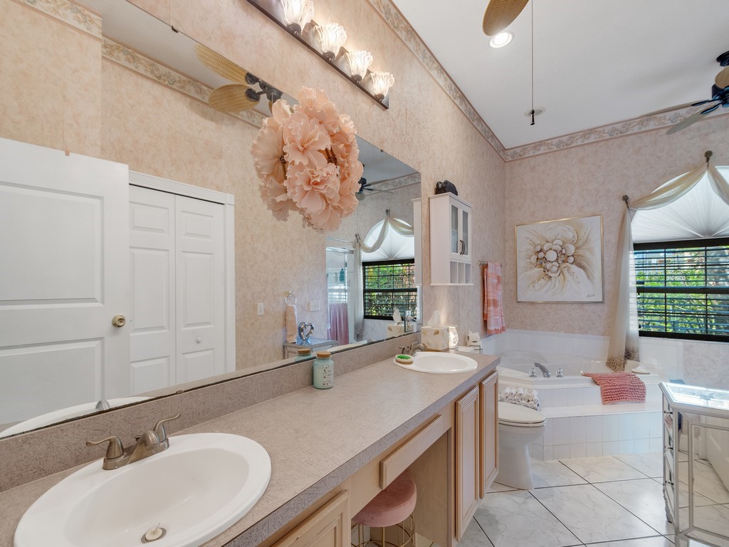 10615 Highway 1 Sebastian, FL 32958 - Photo 16 of 33 a bathroom with a granite countertop sink and a mirror