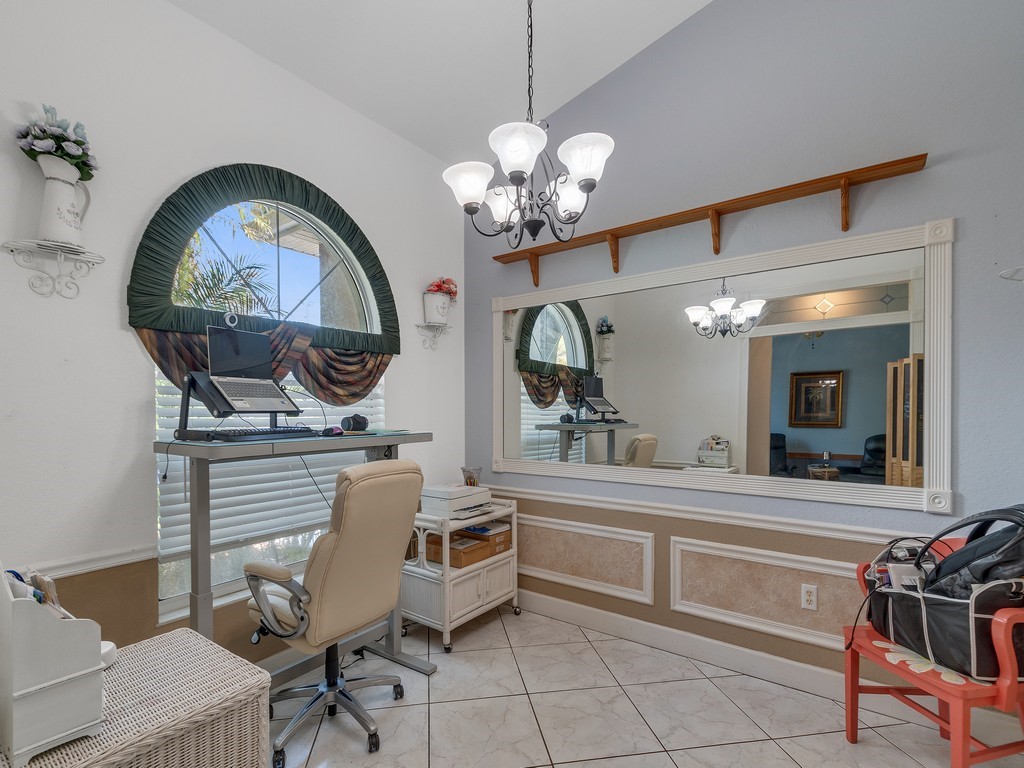 10615 Highway 1 Sebastian, FL 32958 - Photo 21 of 33 a very nice looking dining room with a large mirror and a chandelier