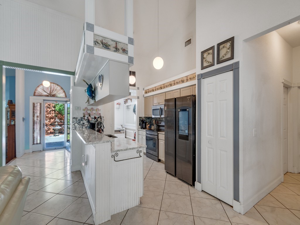10615 Highway 1 Sebastian, FL 32958 - Photo 9 of 33 a living room with furniture and a kitchen