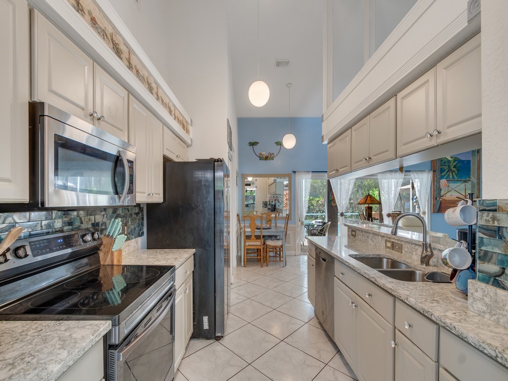 10615 Highway 1 Sebastian, FL 32958 - Photo 10 of 33 a kitchen with stainless steel appliances granite countertop a sink and a stove