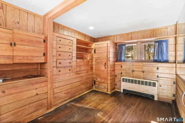 a view of walk in closet with clothes