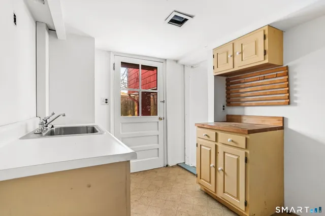 a view of a house with a large tree