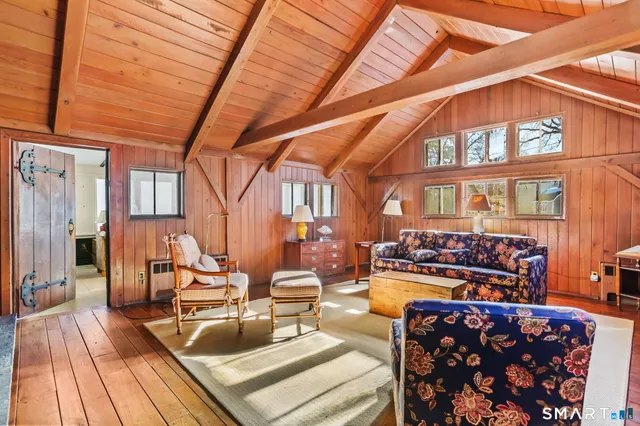 a living room with furniture a rug and white walls