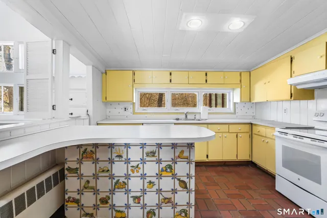 a kitchen with stainless steel appliances granite countertop a sink and cabinets
