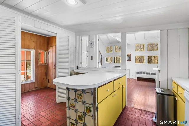 a kitchen with stainless steel appliances granite countertop a sink and a refrigerator