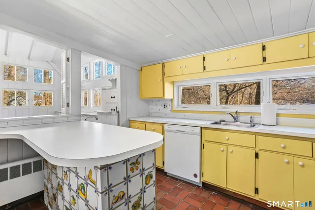a kitchen with stainless steel appliances granite countertop a sink and cabinets