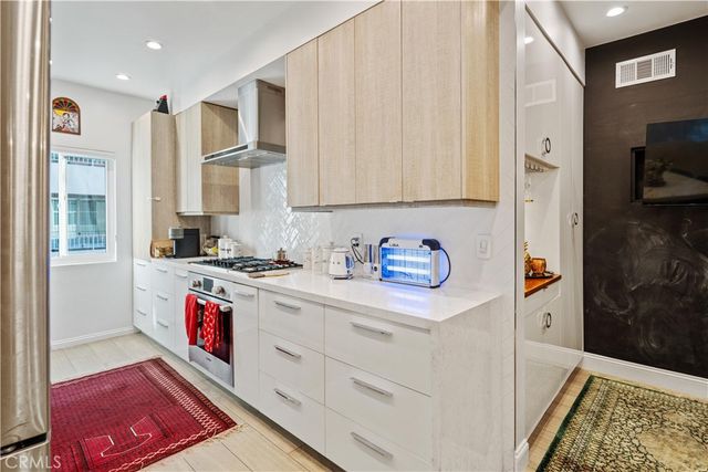 a kitchen with stainless steel appliances granite countertop a sink and cabinets