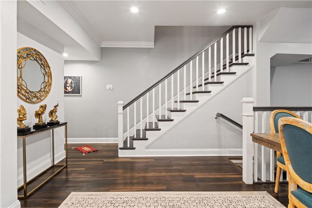 a view of entryway and hall with wooden floor