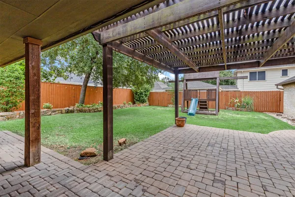 a view of a house with a backyard and a slide
