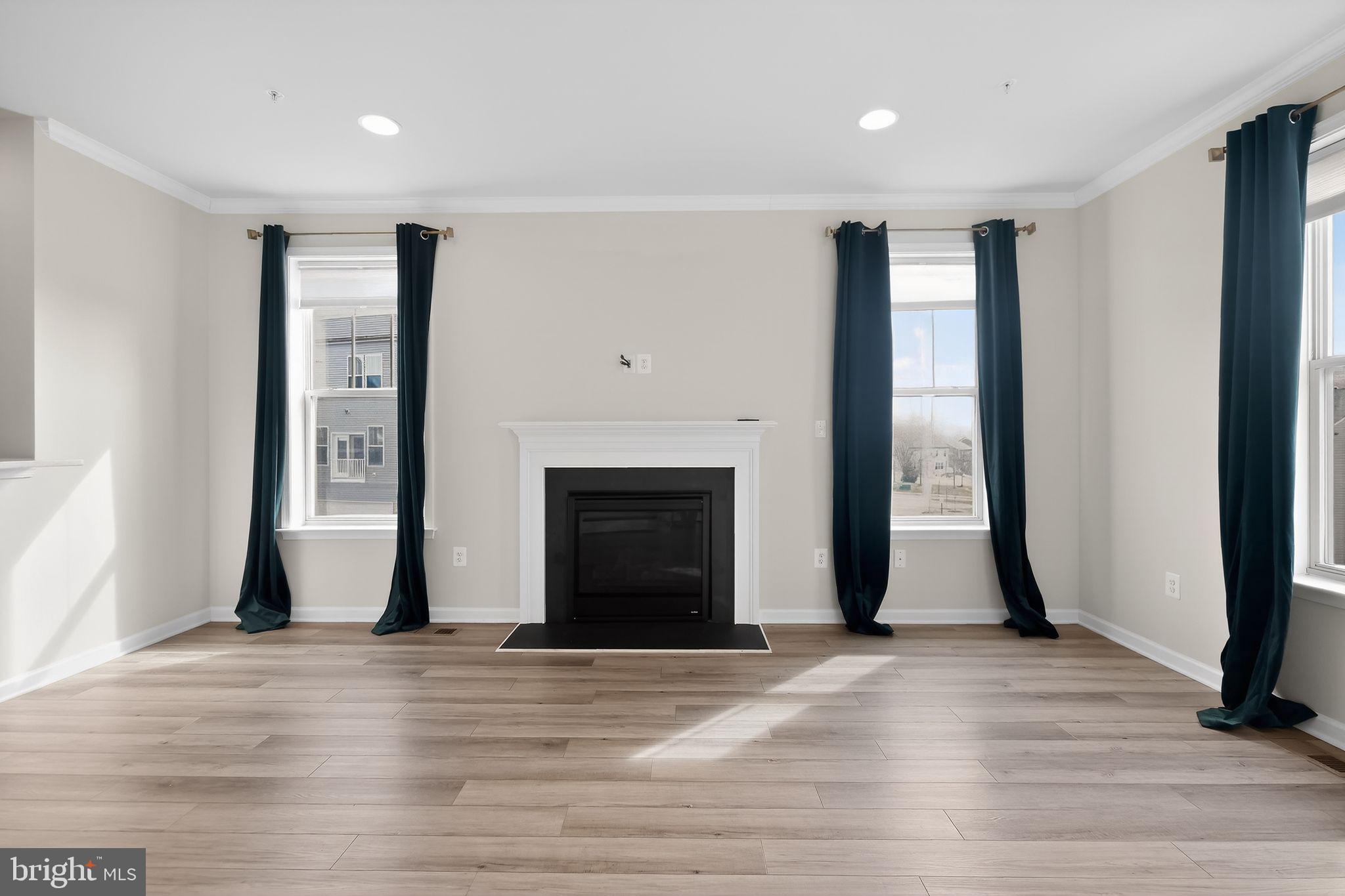 1518 Ricketts Road Frederick, MD 21702 - Photo 13 of 32 a view of a livingroom with wooden floor and a fireplace