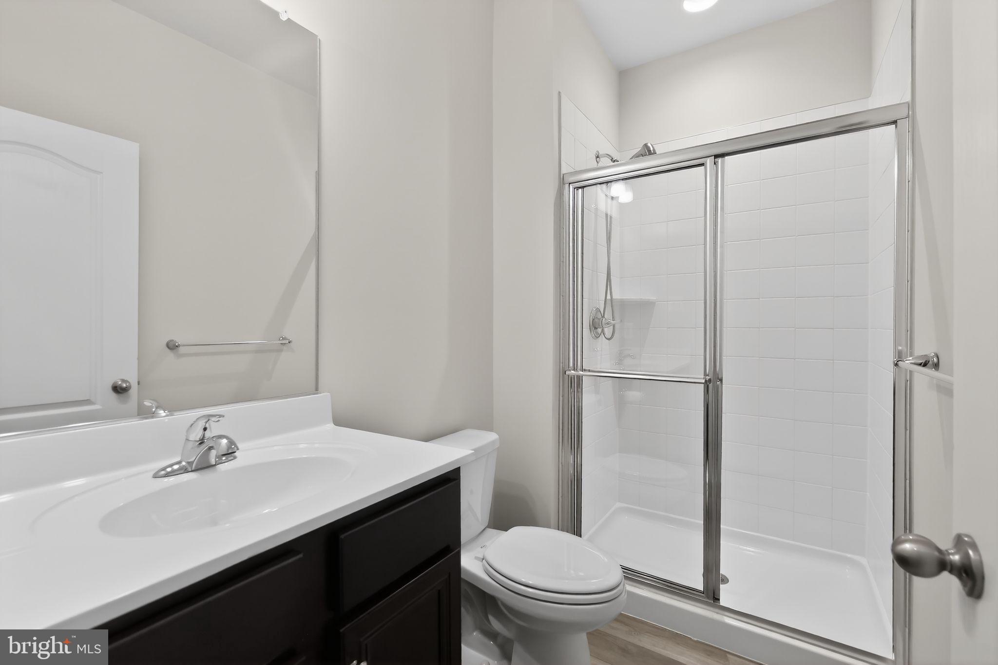 1518 Ricketts Road Frederick, MD 21702 - Photo 17 of 32 a bathroom with a sink toilet and shower