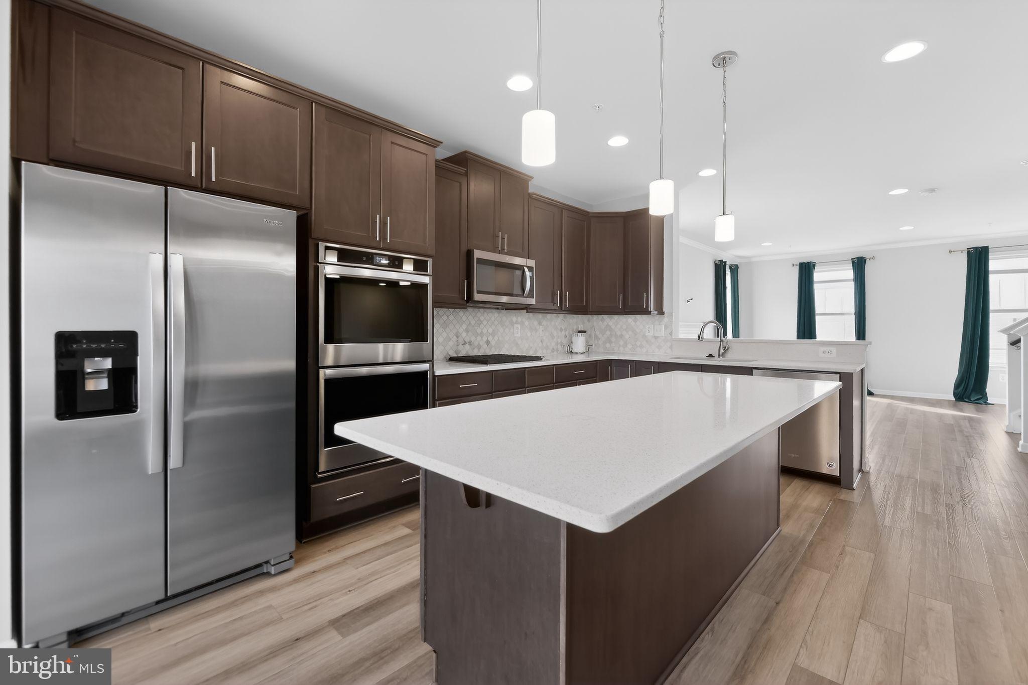 1518 Ricketts Road Frederick, MD 21702 - Photo 10 of 32 a large kitchen with a center island wooden floor stainless steel appliances and cabinets