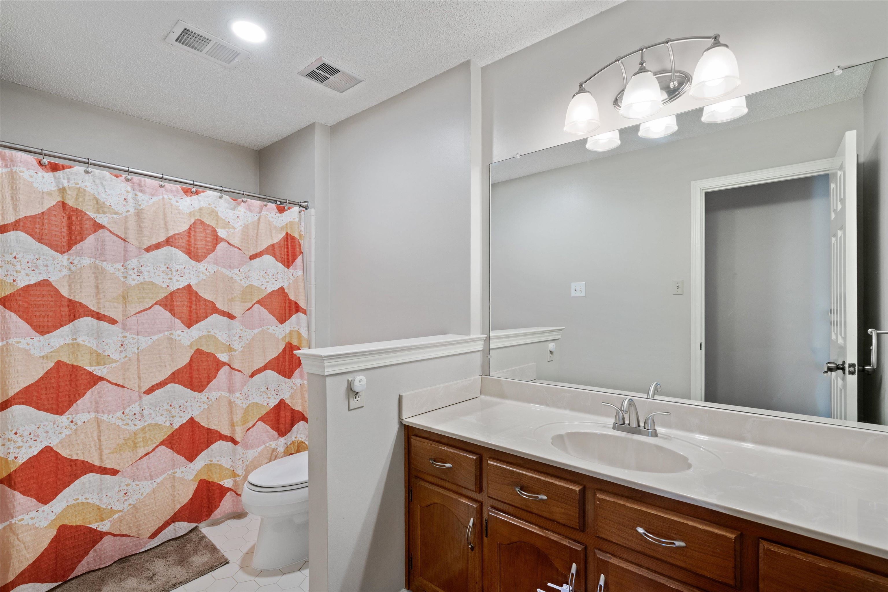 6463 Yale Road Bartlett, TN 38134 - Photo 20 of 29 a bathroom with a sink a toilet and a mirror