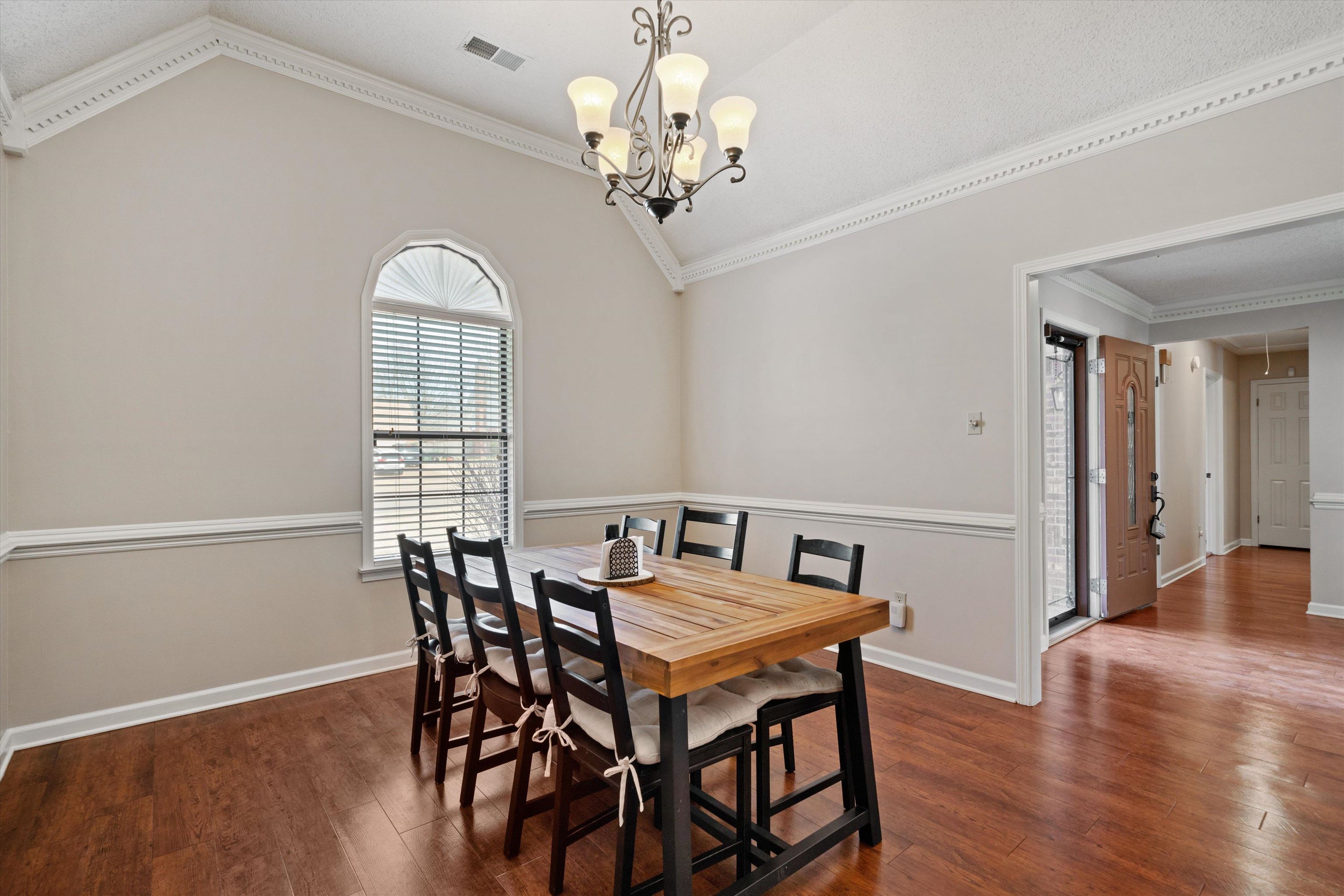 6463 Yale Road Bartlett, TN 38134 - Photo 6 of 29 a view of a dining room with furniture a chandelier and wooden floor
