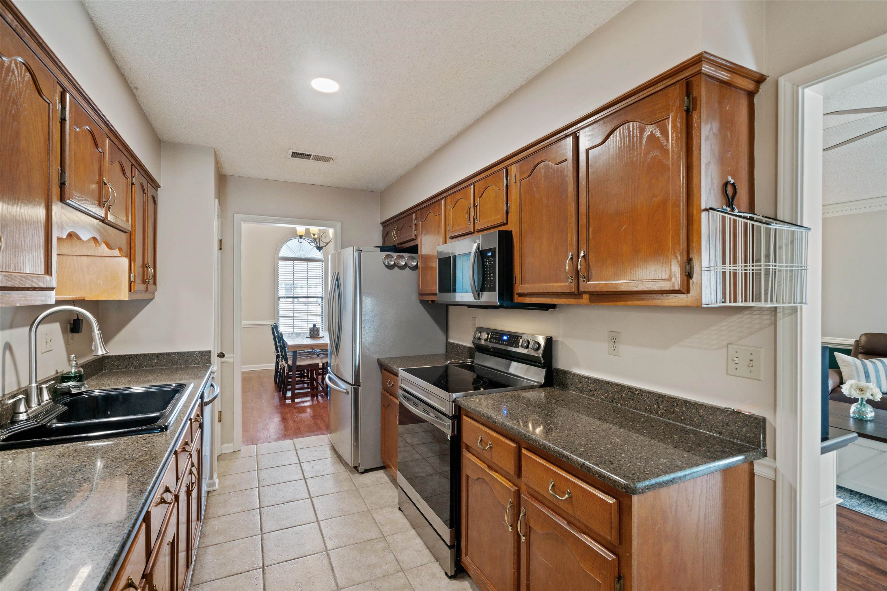 6463 Yale Road Bartlett, TN 38134 - Photo 8 of 29 a kitchen with stainless steel appliances granite countertop a sink stove and cabinets
