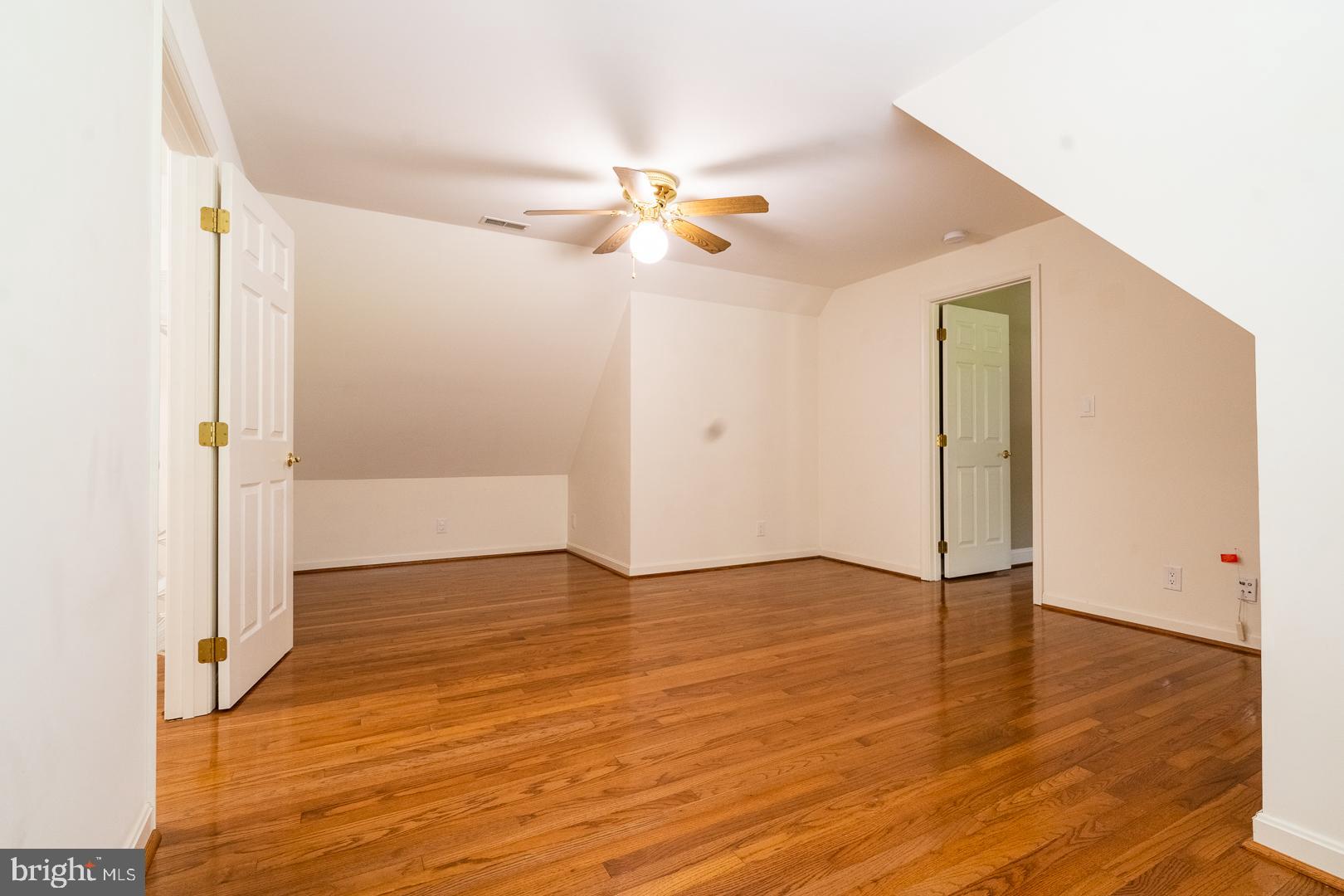 5705 Solomons Island Road St. Leonard, MD 20685 - Photo 23 of 46 a view of an empty room with wooden floor