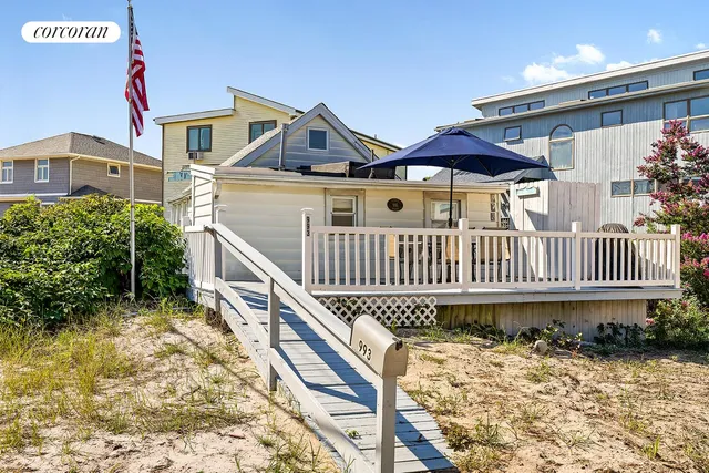 a view of a house with wooden fence