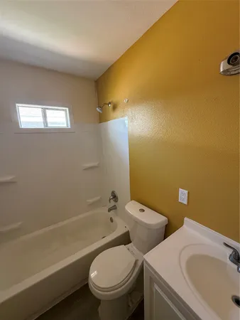 a bathroom with a toilet sink and bathtub