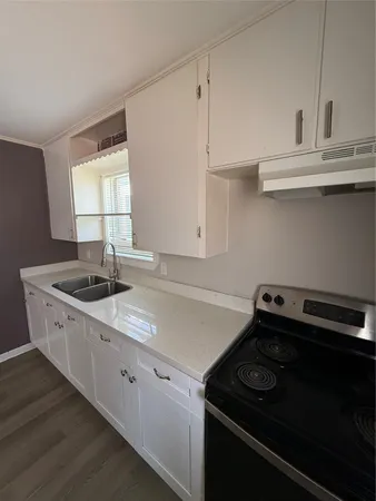 a kitchen with a stove and a sink