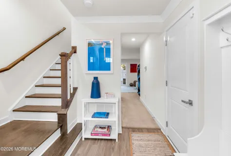 a view of entryway and hall with wooden floor