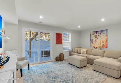 a kitchen with stainless steel appliances granite countertop a stove a refrigerator a kitchen island a stove and white cabinets