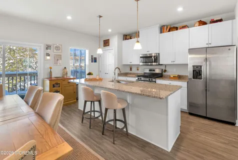 a large kitchen with a table and chairs