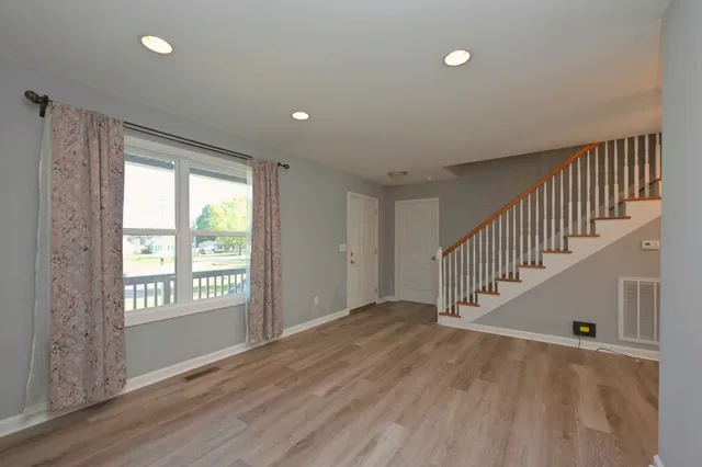 a spacious bedroom with a large bed and a flat screen tv