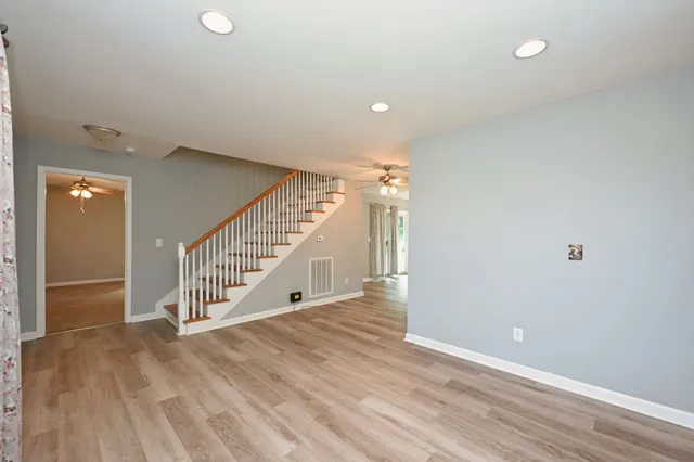 a view of a livingroom with a ceiling fan and window