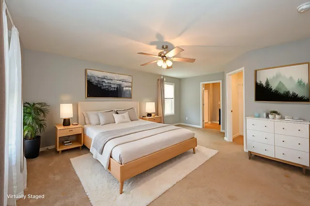 an empty room with windows and ceiling fan