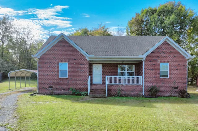 a dining room with furniture a chandelier and wooden floor