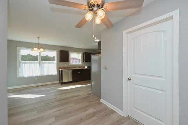 an empty room with wooden floor and entrance