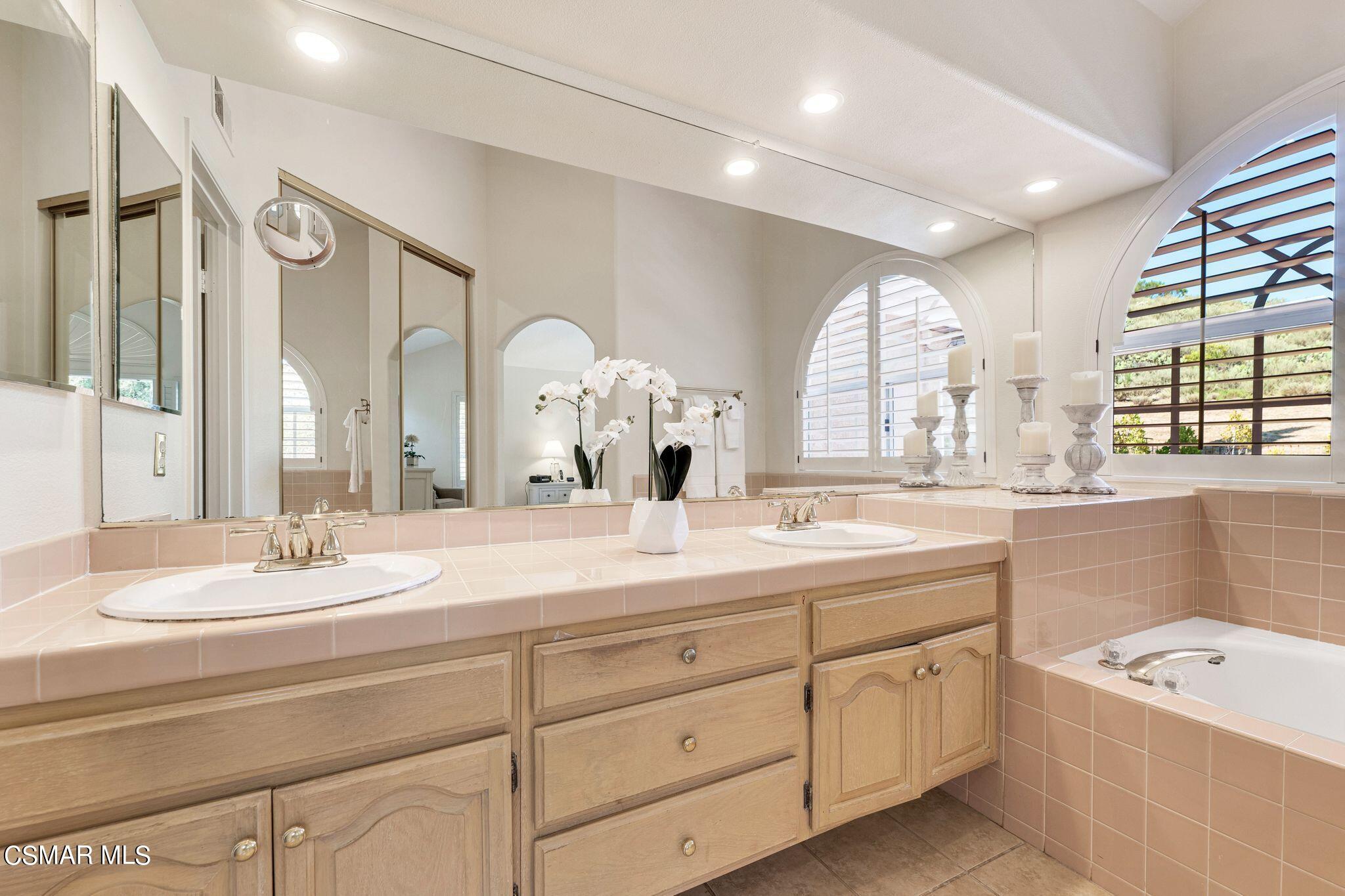 506 Innwood Road Simi Valley, CA 93065 - Photo 29 of 54 a bathroom with a granite countertop sink mirror bathtub and next