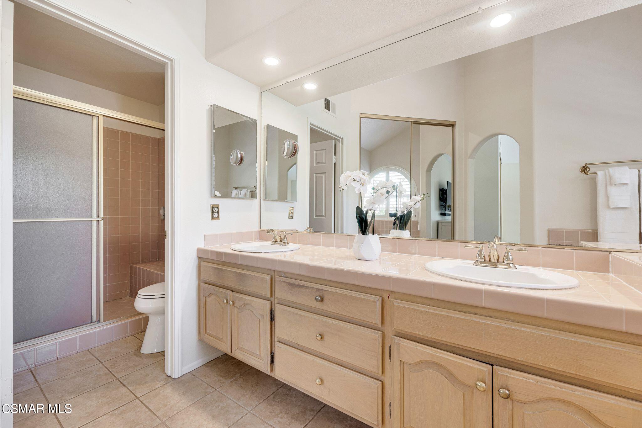 506 Innwood Road Simi Valley, CA 93065 - Photo 30 of 54 a bathroom with a double vanity sink and mirror