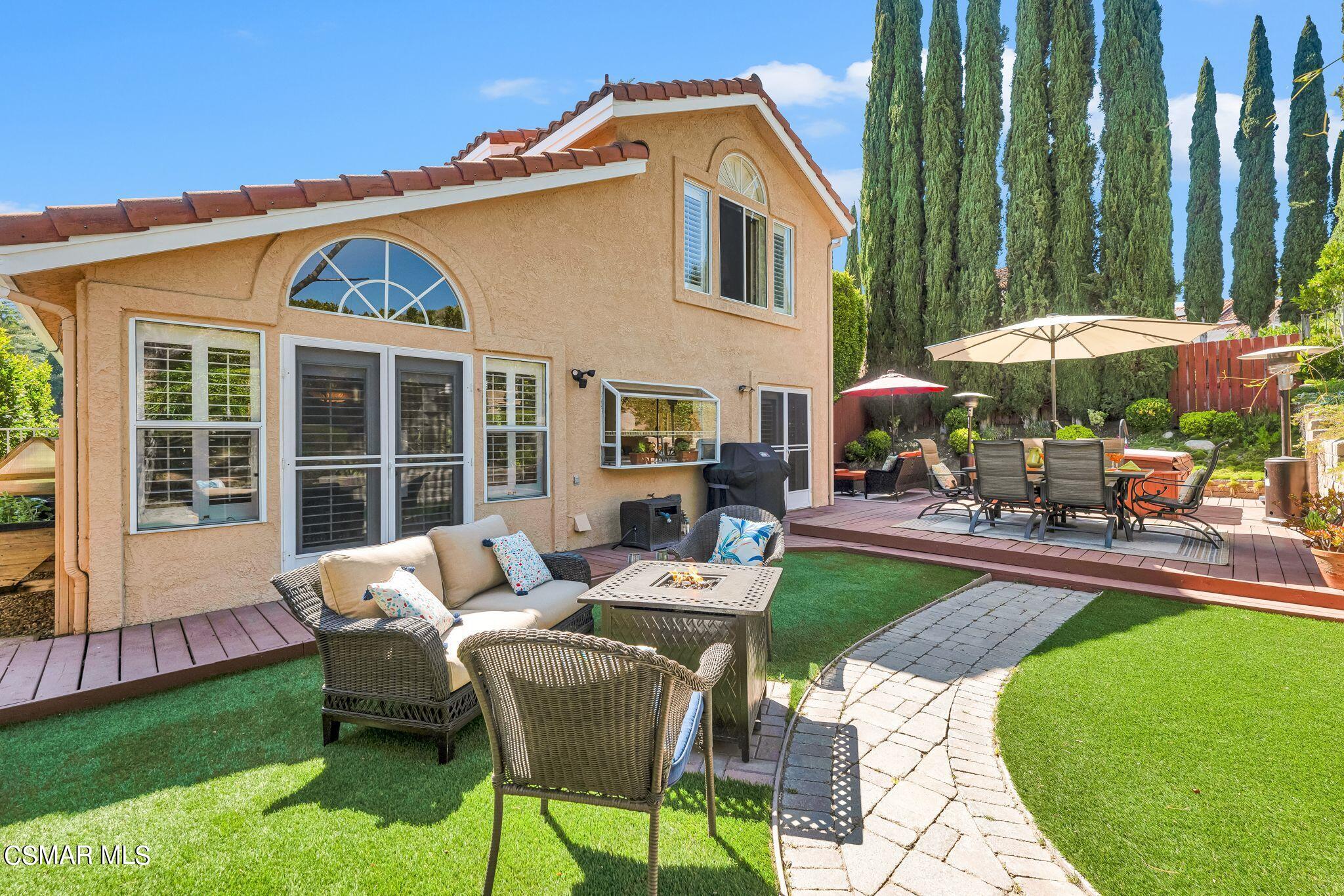 506 Innwood Road Simi Valley, CA 93065 - Photo 39 of 54 a patio with a table and chairs under an umbrella