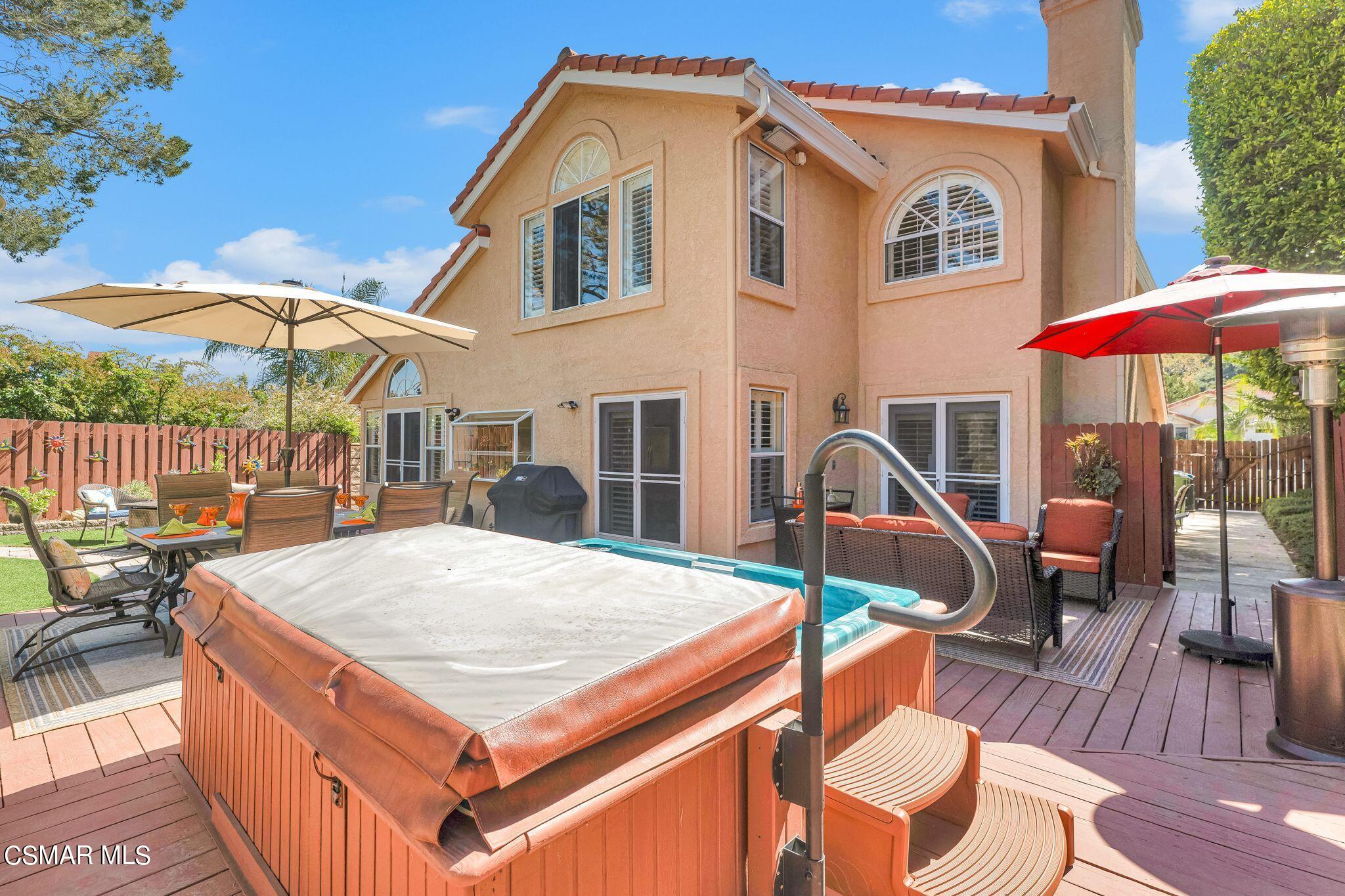 506 Innwood Road Simi Valley, CA 93065 - Photo 45 of 54 a view of a patio with a table and chairs under an umbrella