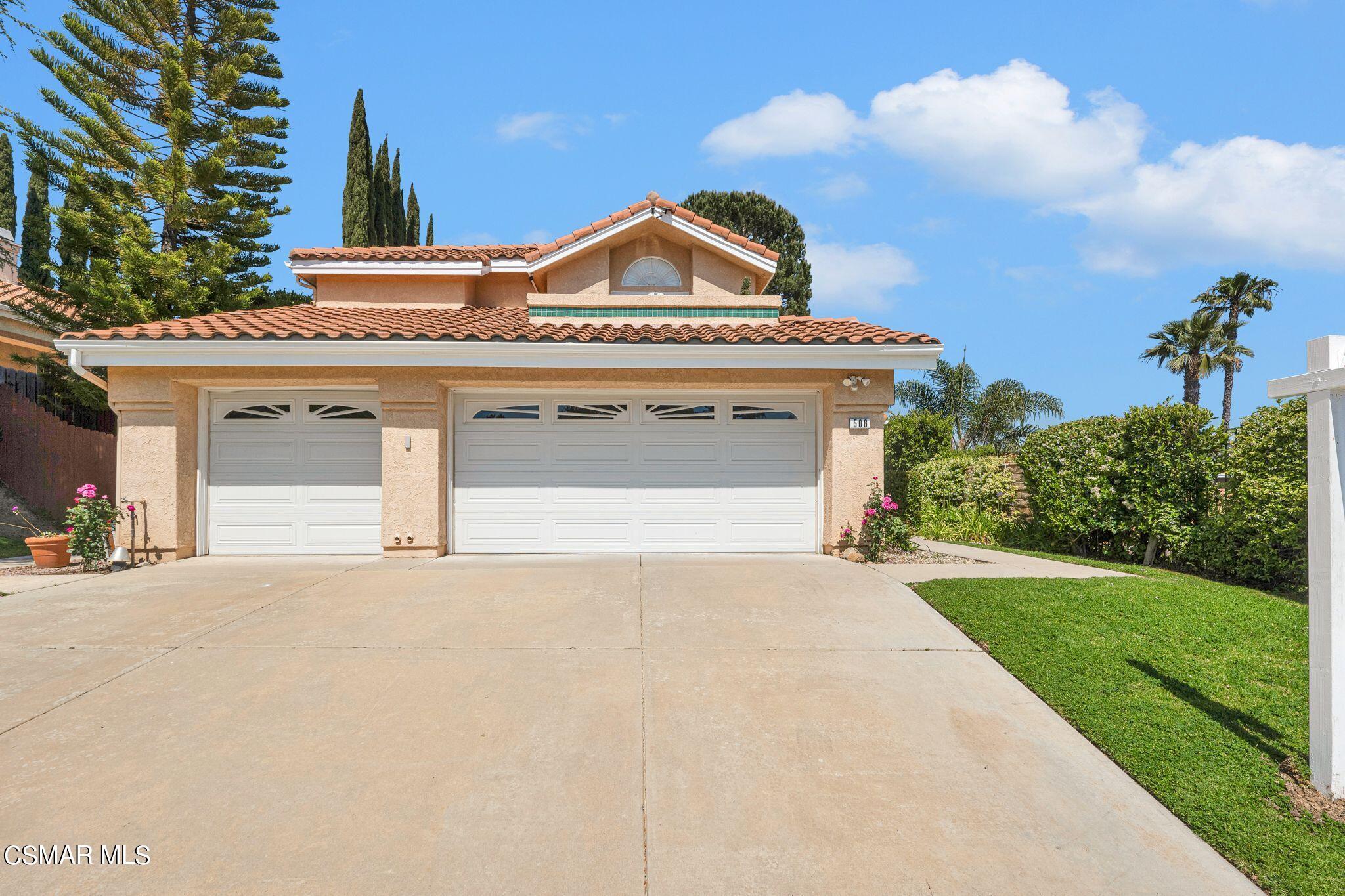 506 Innwood Road Simi Valley, CA 93065 - Photo 5 of 54 a front view of a house with a yard and garage